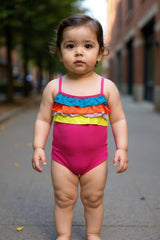 baby wearing a Carter's rainbow ruffle swimsuit